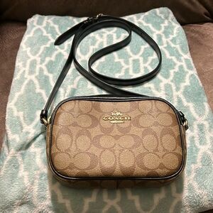 Coach crossbody 71/2 by 5 brown and trimmed with black, black strap strap 42in